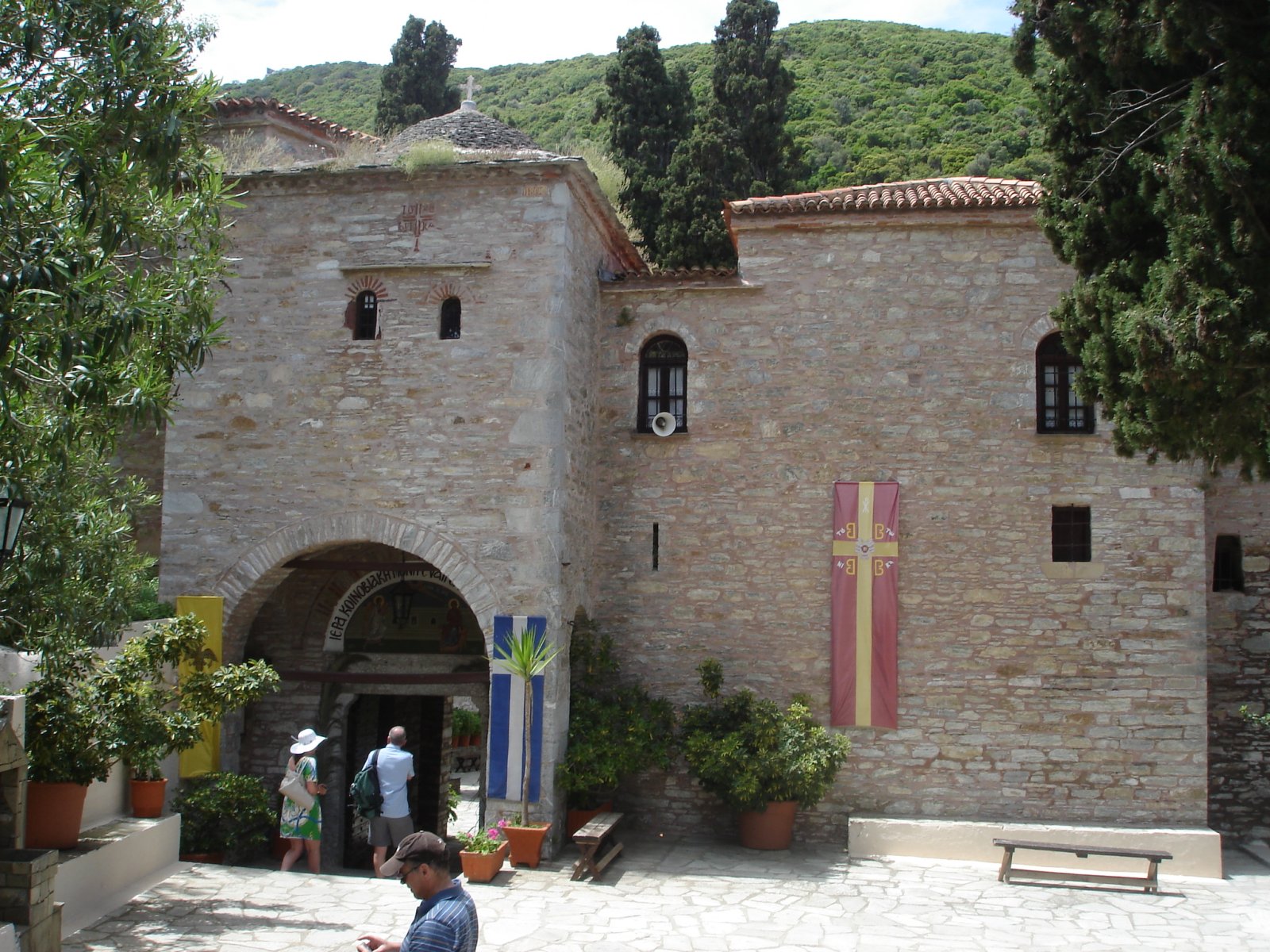 The Monastery of Panagias Evangelistrias and the Greek flag - Moni Evaggelistrias | Secret World Trip Planner